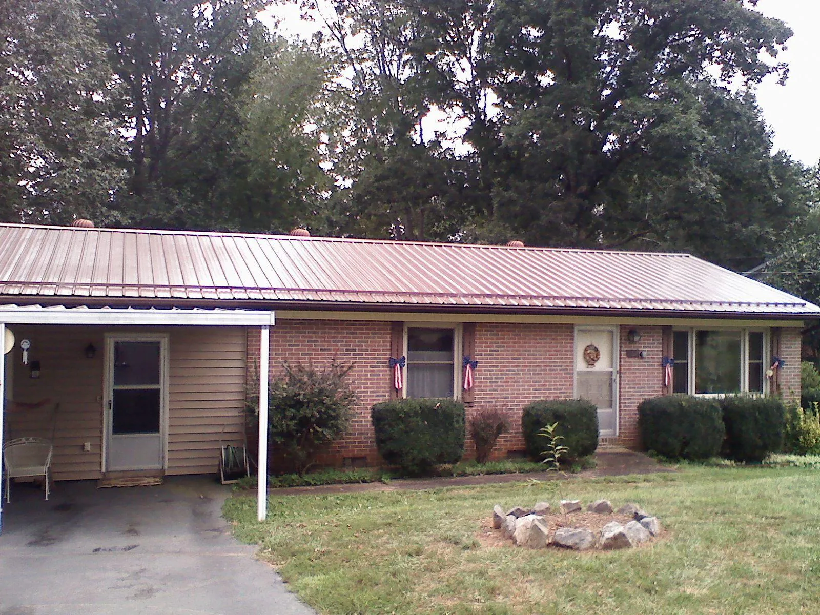 Bronze metal roof and carport on a brick ranch home — Roof Repair work by our crew in East Ryegate